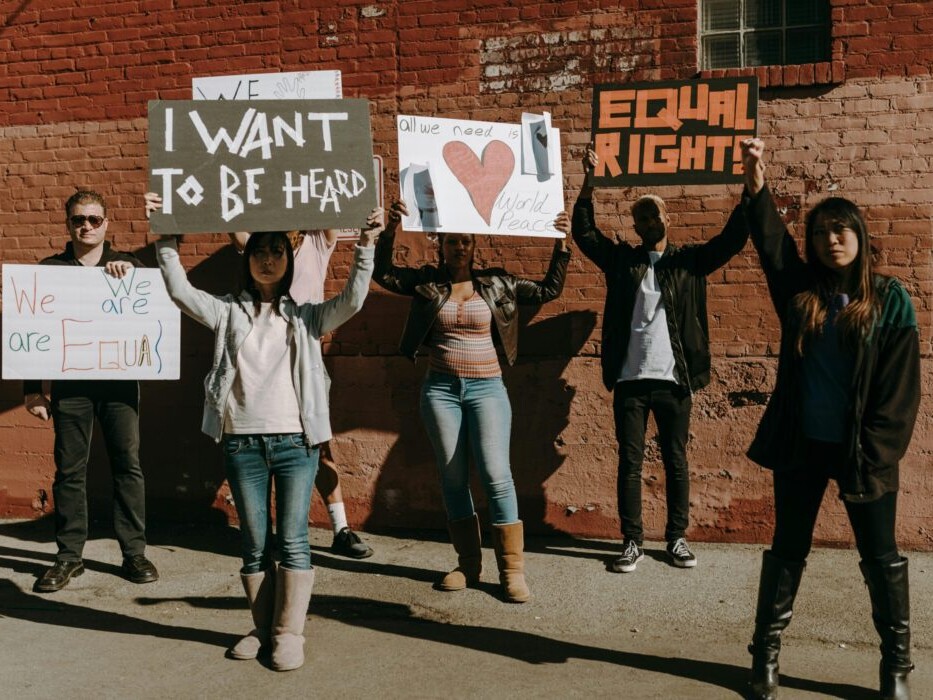 young people holding signs