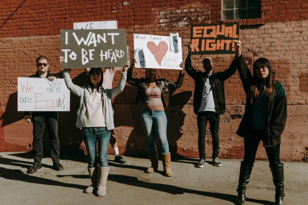 young people holding signs